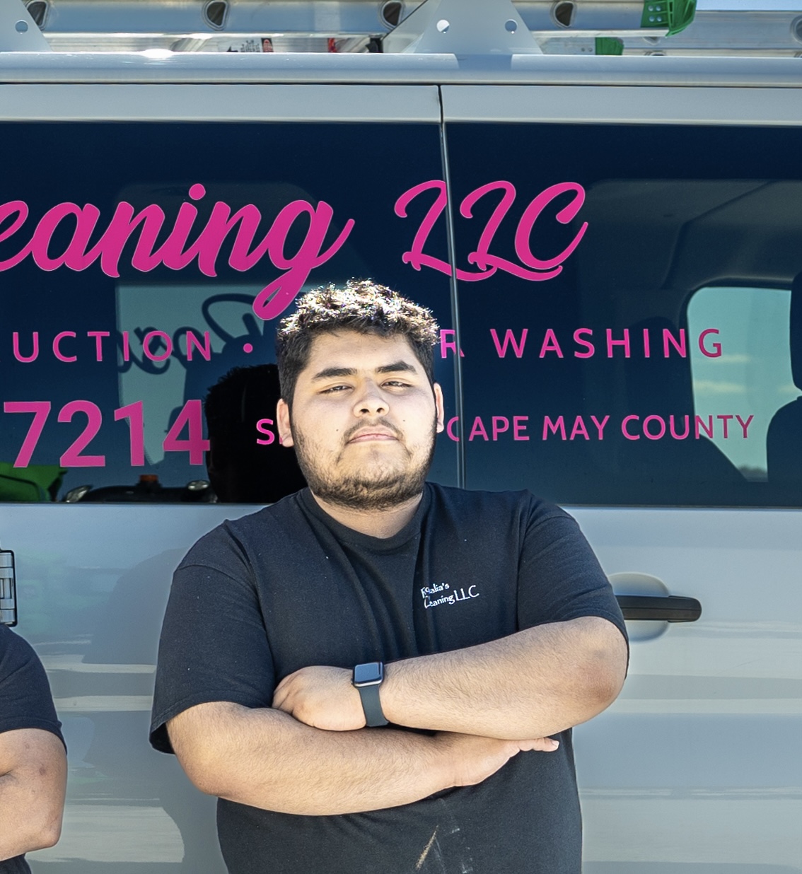 Oscar Montoya standing in front of a Rosalia's Cleaning Services vehicle
